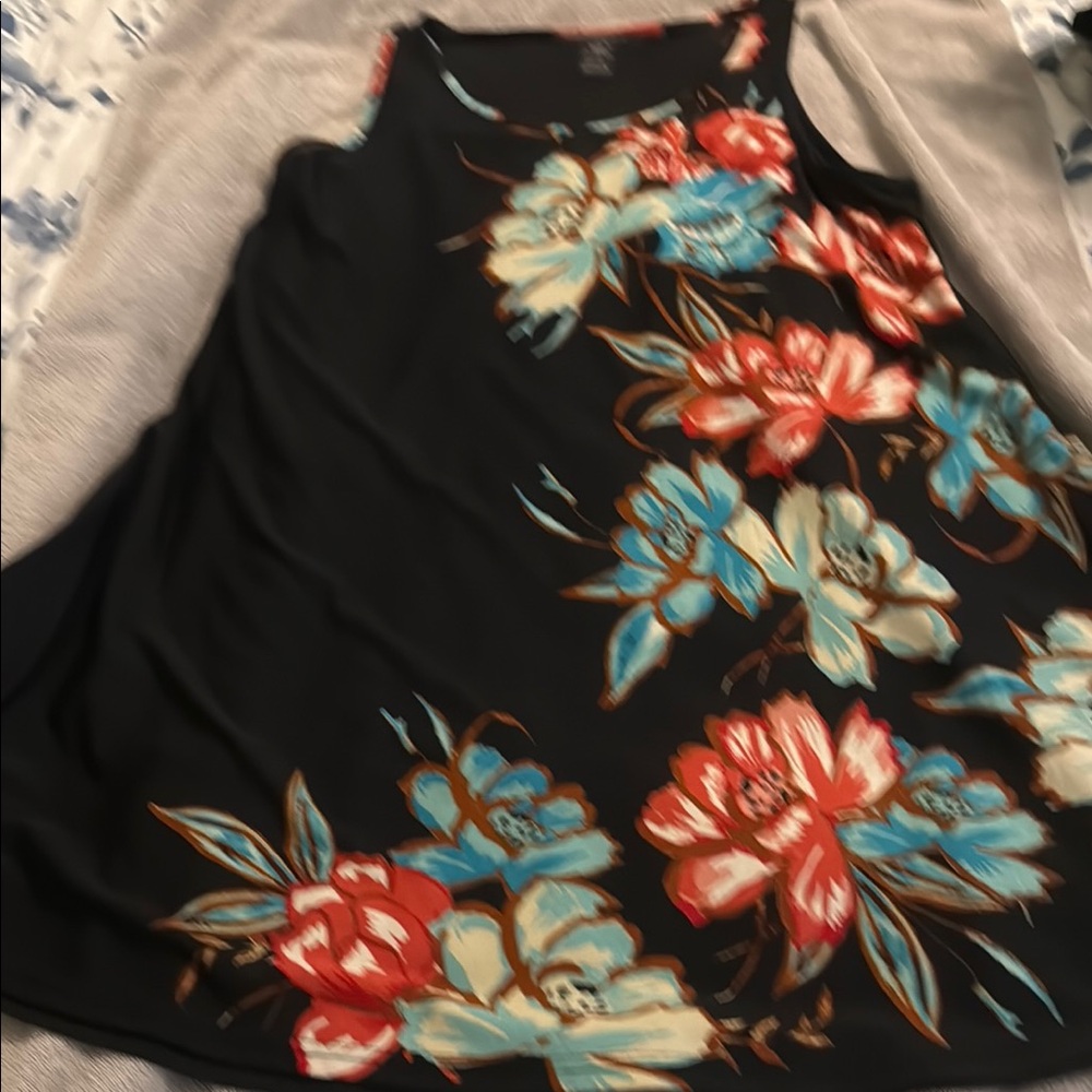 Asymmetrical black dress with tropical flowers. Mid knee